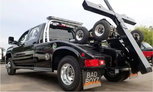 a black truck with a large black object on the back